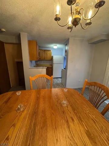 a bedroom with a bed dresser and a chandelier