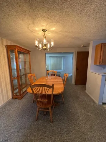 a dining room with furniture and a chandelier