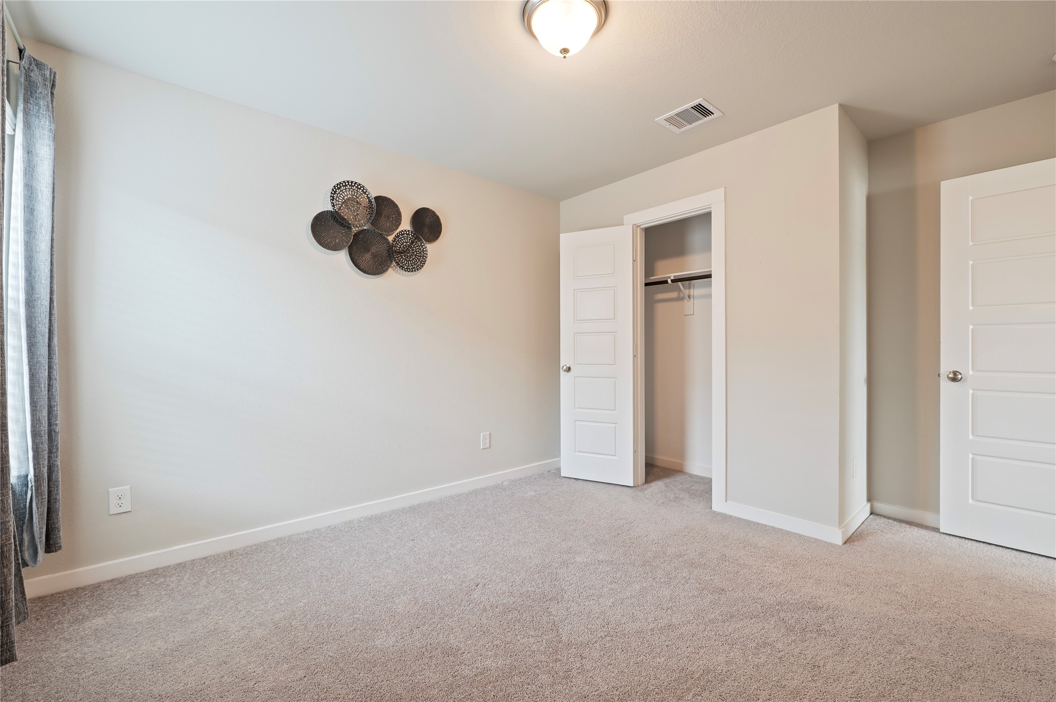 2107 Santa Ana Way Baytown, TX 77523 - Photo 16 of 40 an empty room with windows and closet