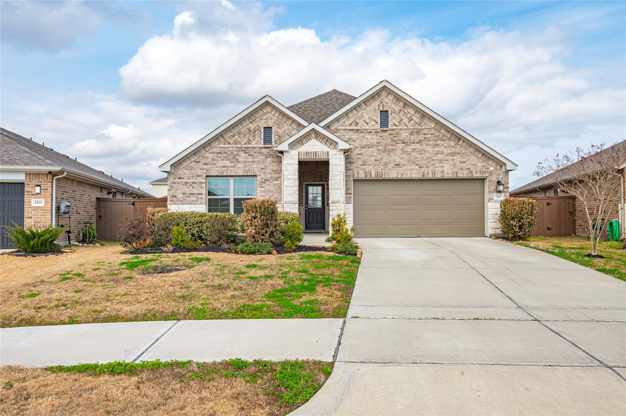 2107 Santa Ana Way Baytown, TX 77523 - Photo 2 of 40 a front view of a house with a yard and garage