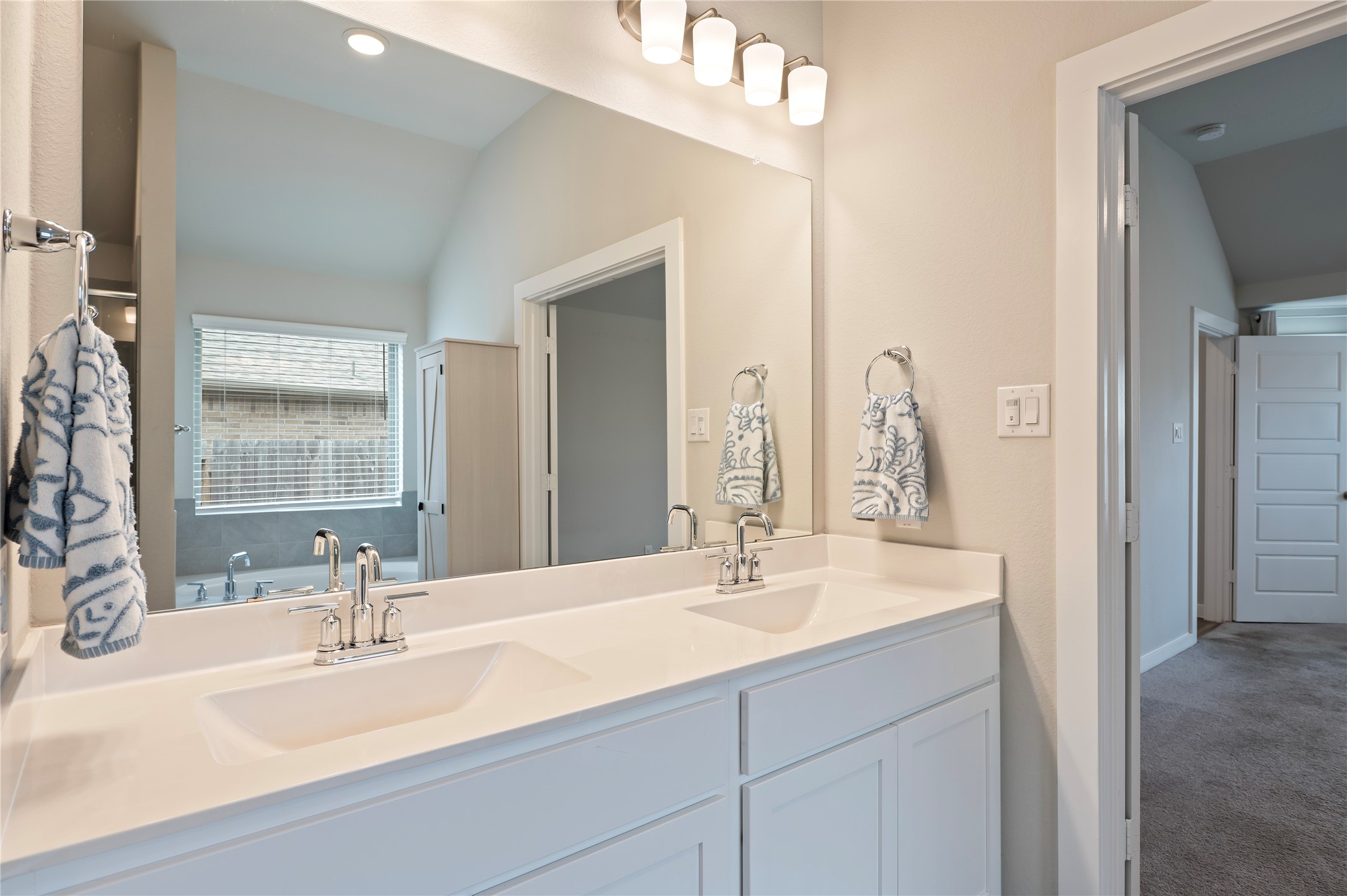 2107 Santa Ana Way Baytown, TX 77523 - Photo 23 of 40 a bathroom with double vanity sinks and a mirror