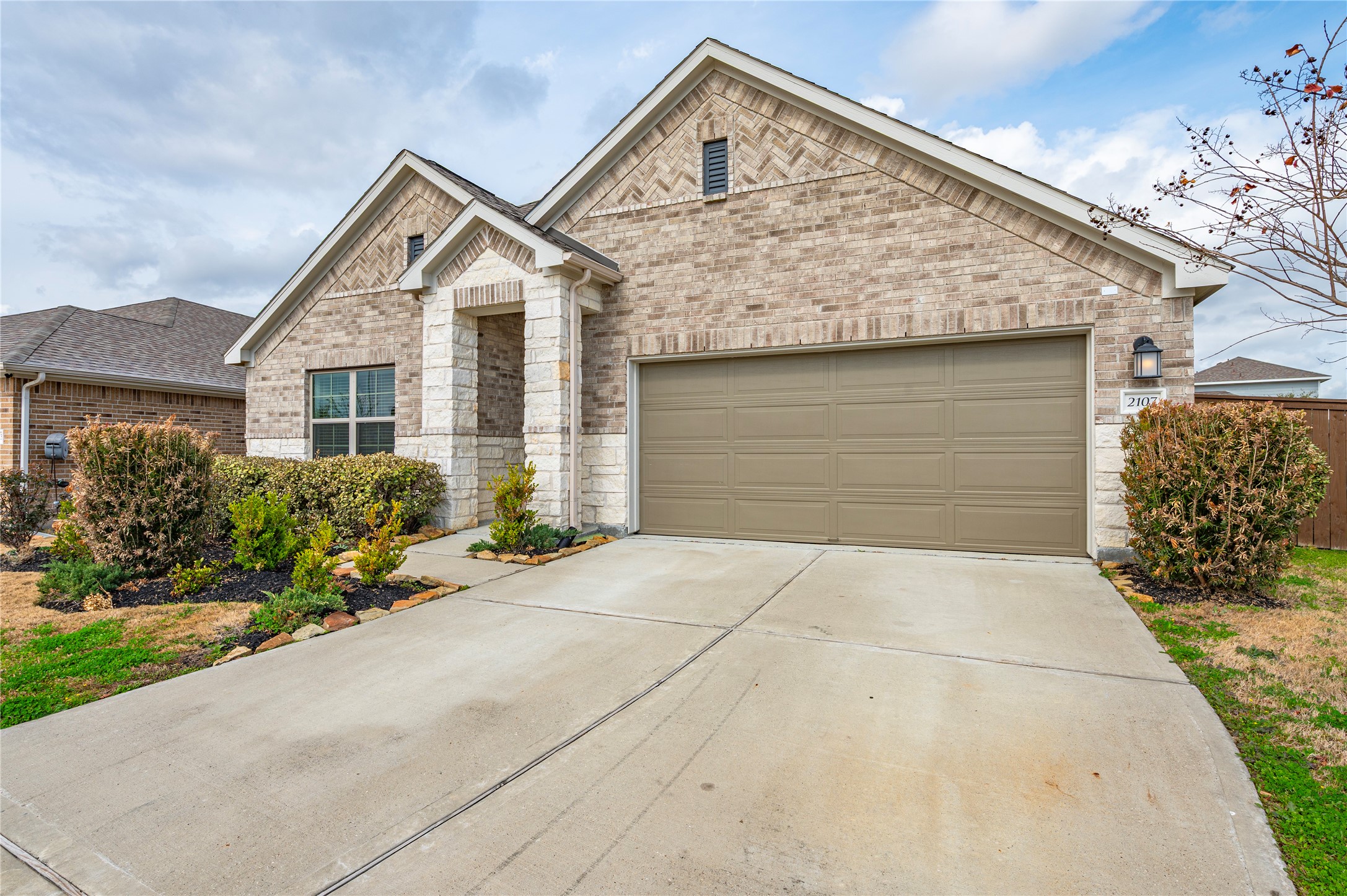 2107 Santa Ana Way Baytown, TX 77523 - Photo 3 of 40 a front view of a house with a yard and garage