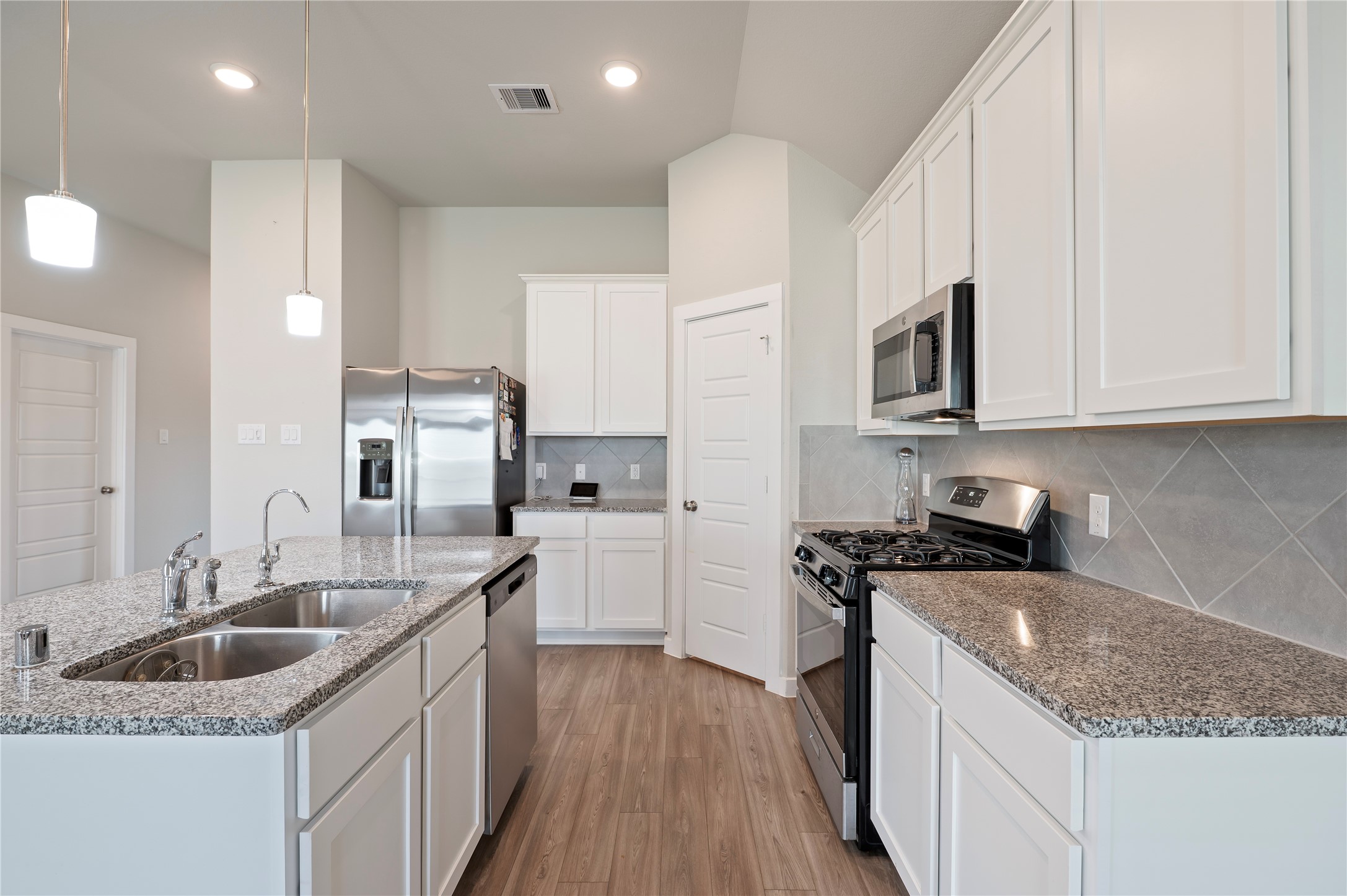 2107 Santa Ana Way Baytown, TX 77523 - Photo 5 of 40 a kitchen with stainless steel appliances granite countertop a sink stove and cabinets