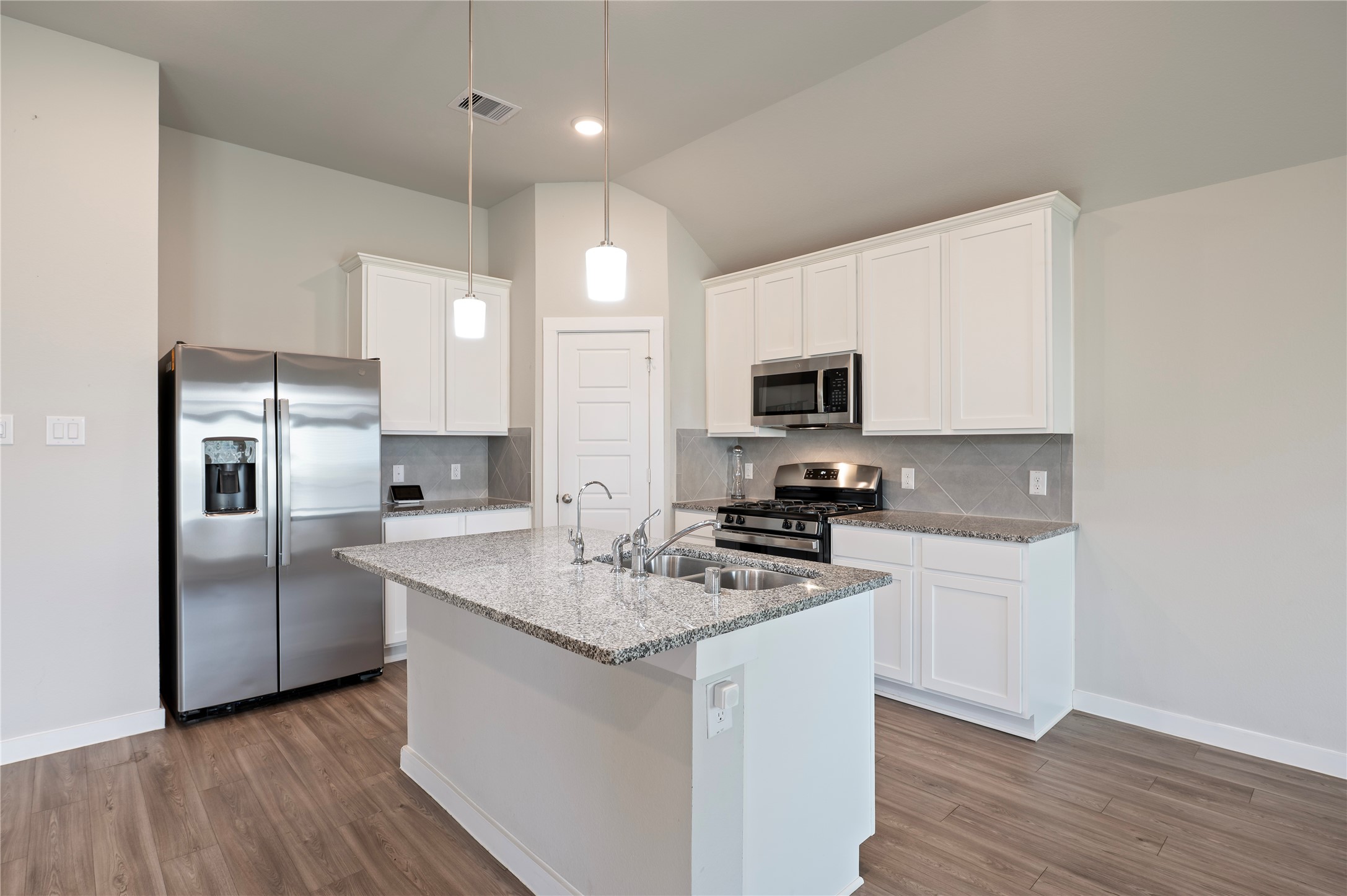 2107 Santa Ana Way Baytown, TX 77523 - Photo 7 of 40 a kitchen with appliances a sink cabinets and wooden floor