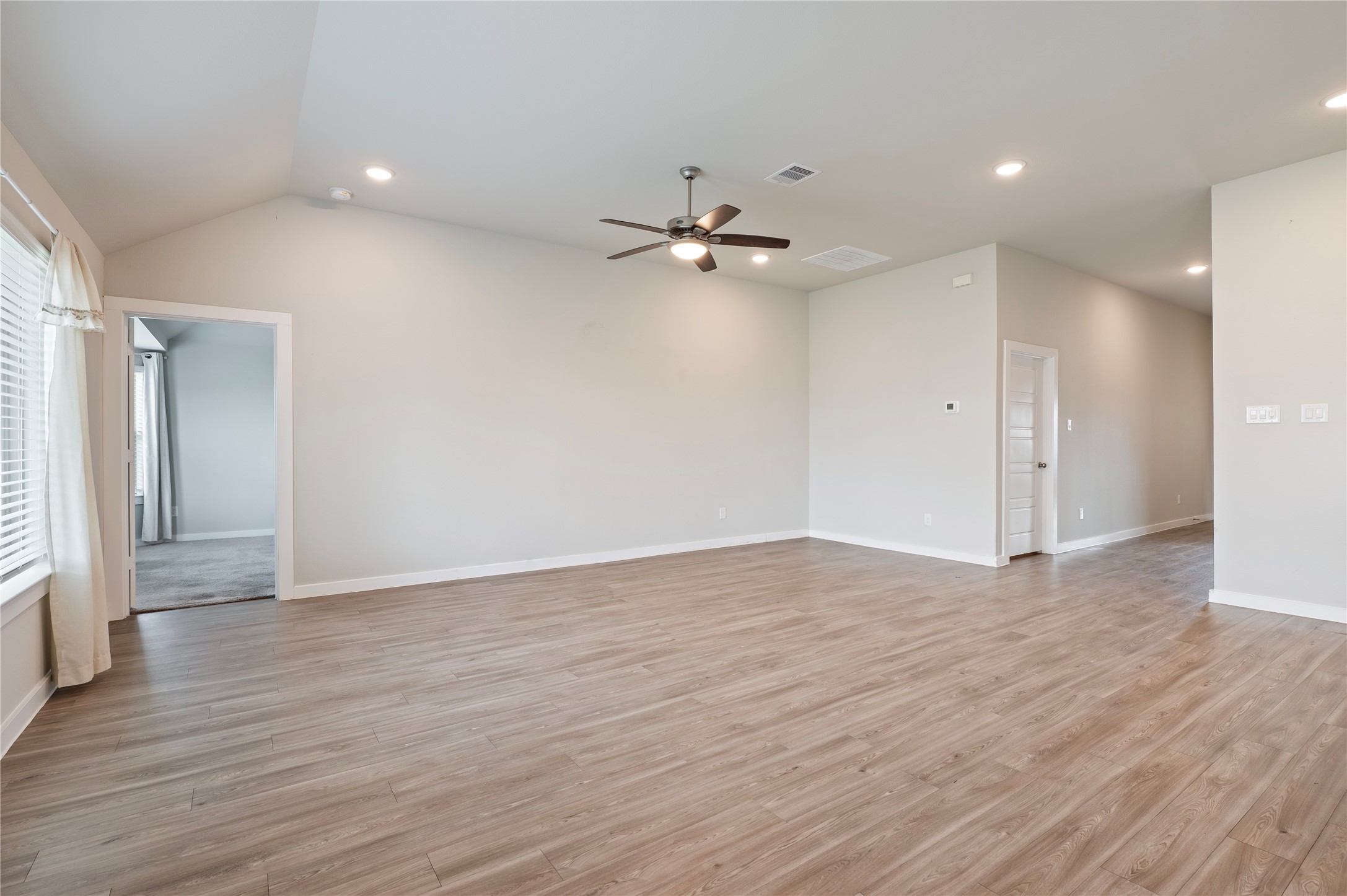 2107 Santa Ana Way Baytown, TX 77523 - Photo 10 of 40 wooden floor in an empty room with a window