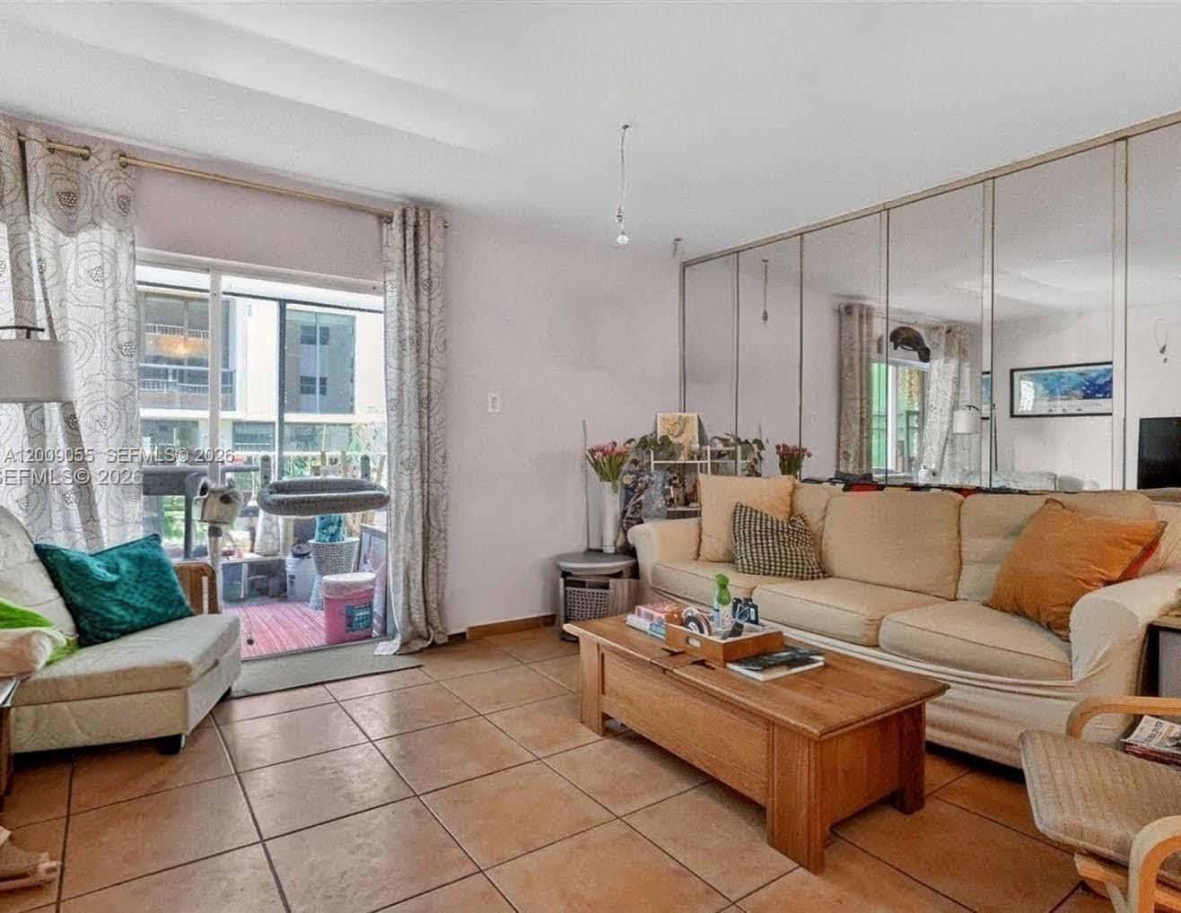 3304 Virginia Street, Unit 3D Miami, FL 33133 - Photo 13 of 19 a living room with furniture and a floor to ceiling window