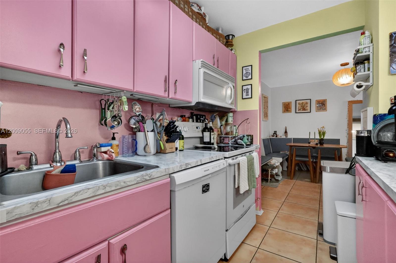 3304 Virginia Street, Unit 3D Miami, FL 33133 - Photo 5 of 19 a kitchen with a sink dishwasher and cabinets with wooden floor