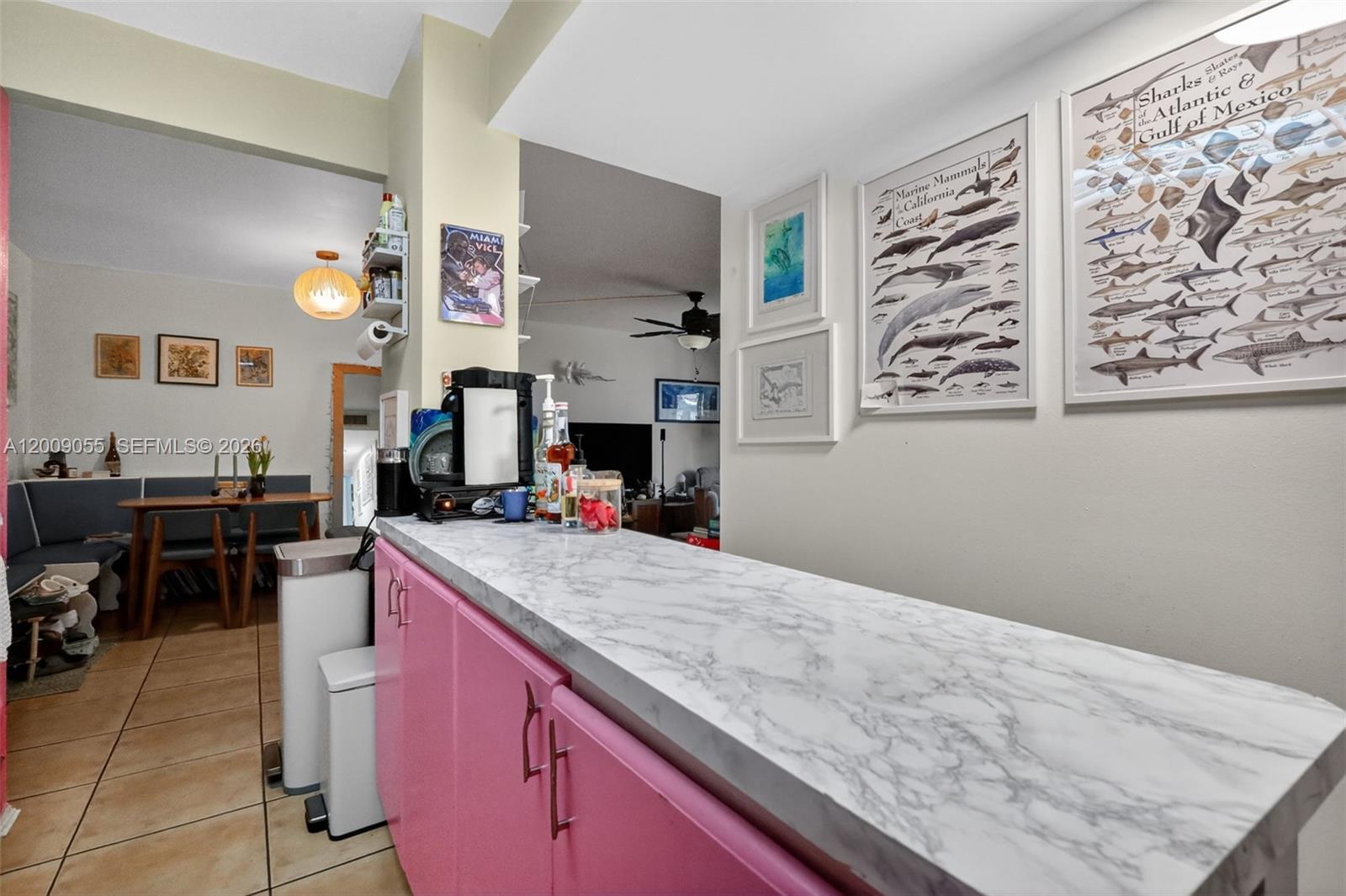 3304 Virginia Street, Unit 3D Miami, FL 33133 - Photo 6 of 19 a kitchen with a stove a refrigerator and a dining table