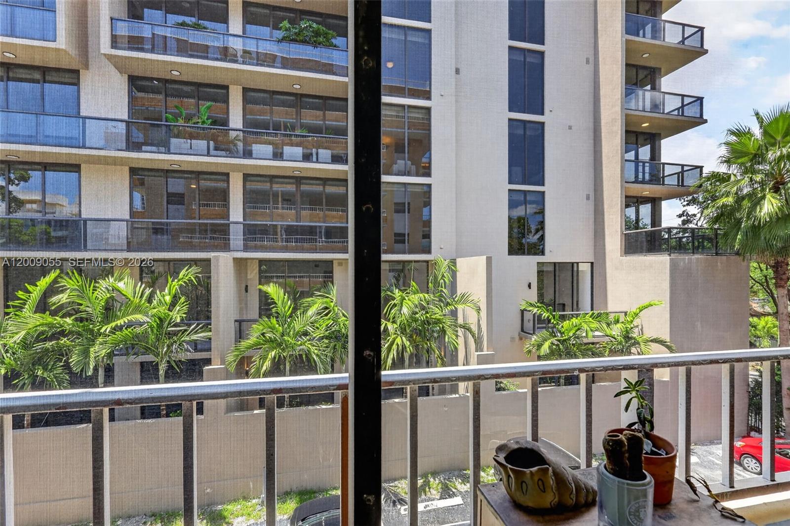 3304 Virginia Street, Unit 3D Miami, FL 33133 - Photo 9 of 19 a view of a balcony with chairs and potted plants