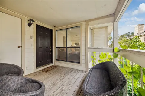 a living room with a couch and a floor to ceiling window