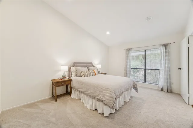 a bedroom with a bed and a night stand