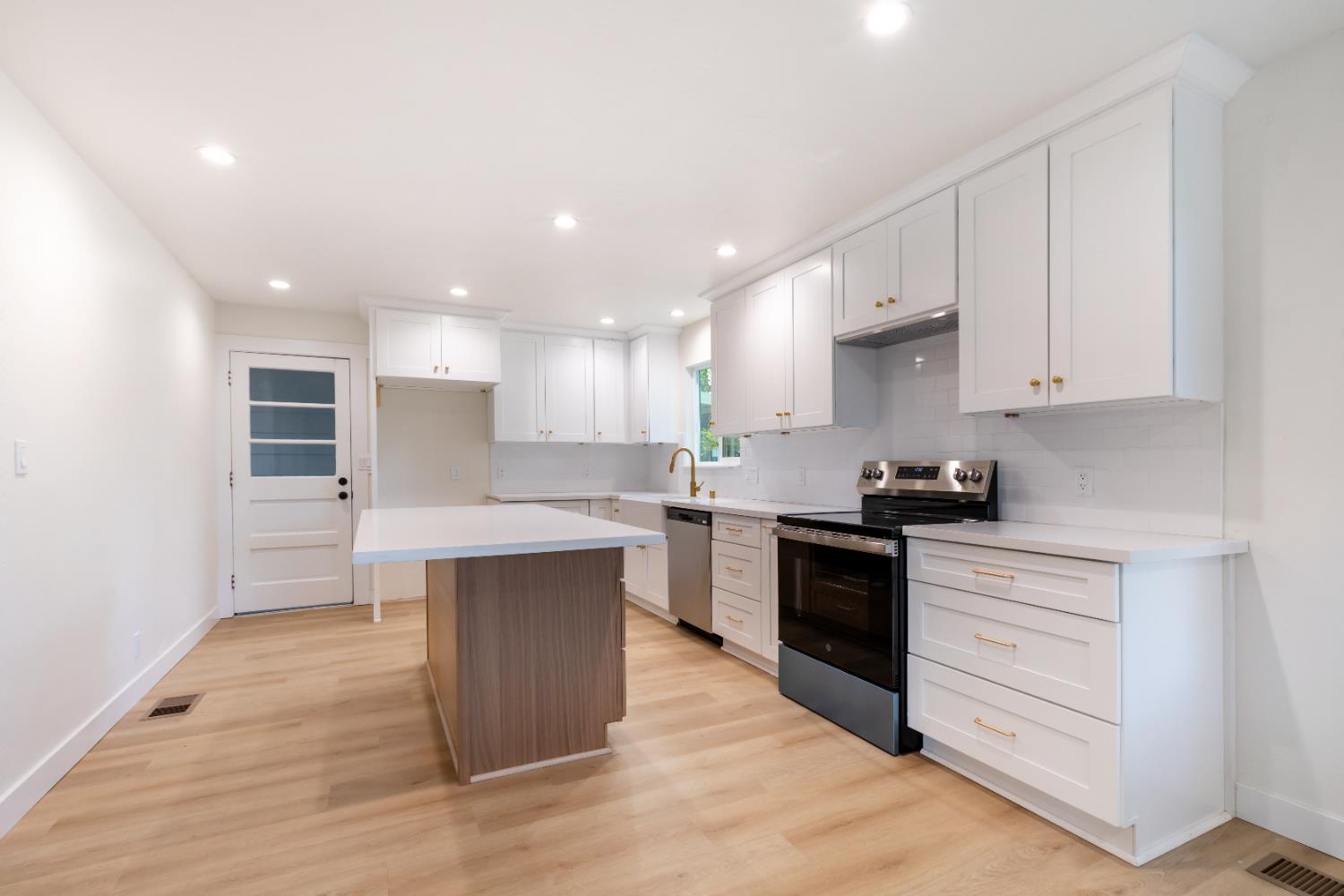 10020 Alta Mesa Road Wilton, CA 95693 - Photo 18 of 56 a kitchen with kitchen island sink stove and cabinets