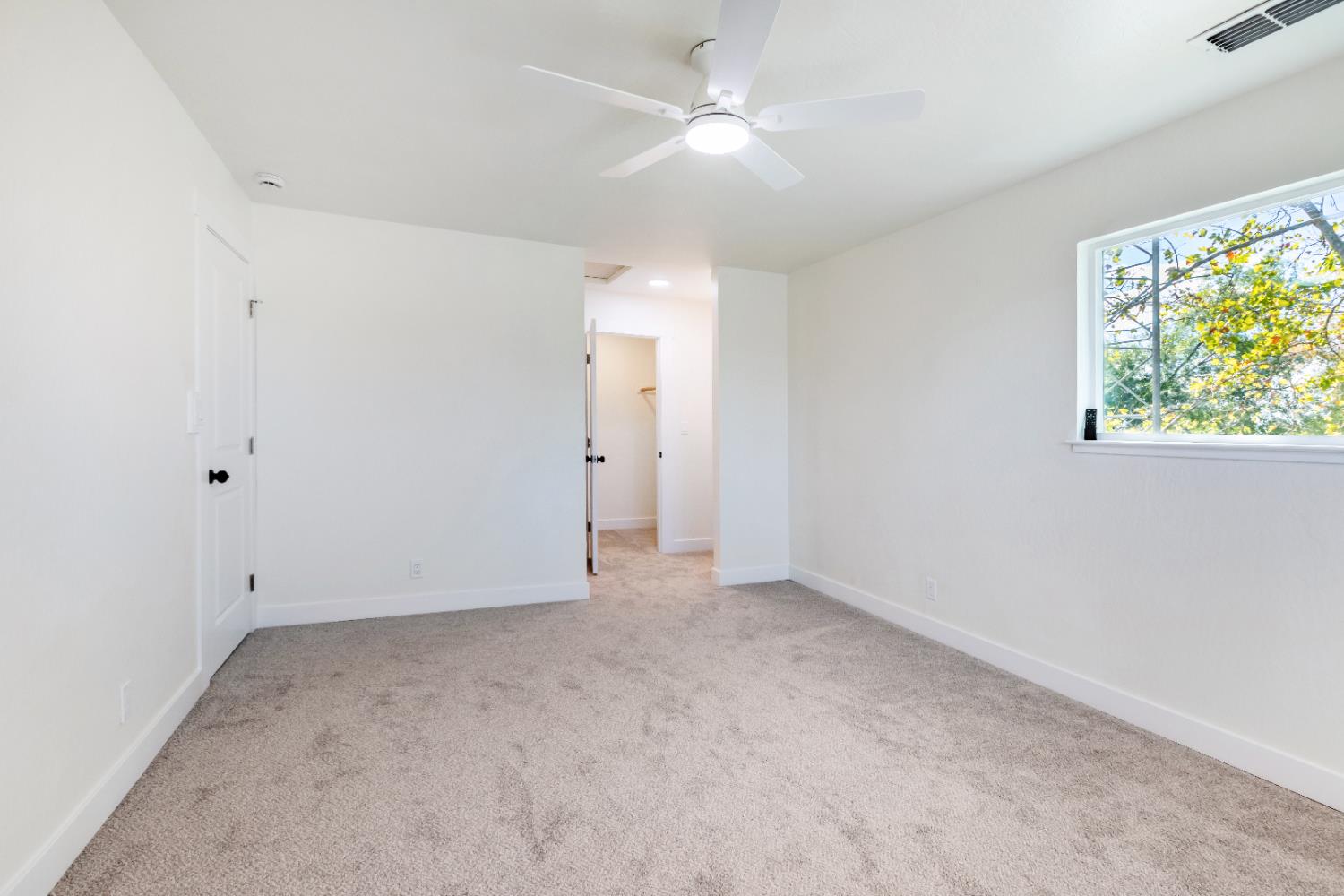10020 Alta Mesa Road Wilton, CA 95693 - Photo 26 of 56 an empty room with a window and a fan