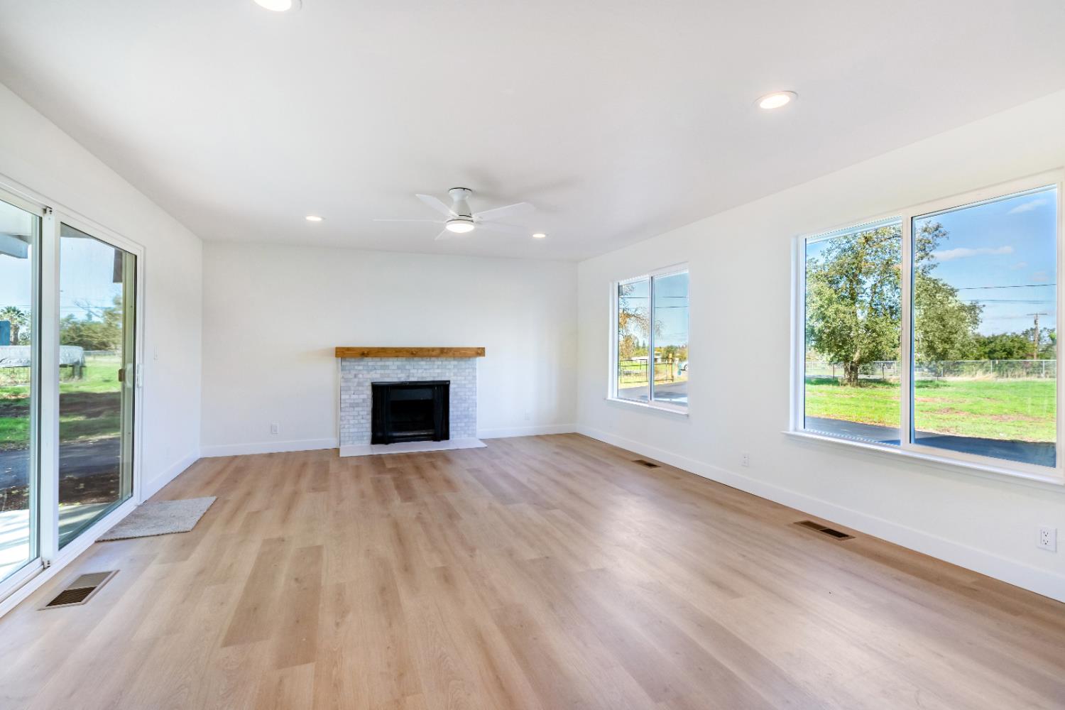 10020 Alta Mesa Road Wilton, CA 95693 - Photo 40 of 56 a view of an empty room with a fireplace and a window