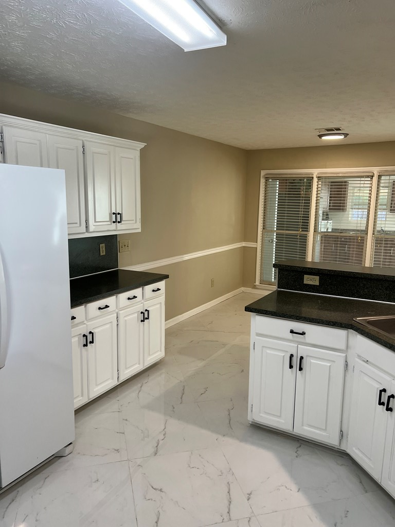 6528 Yellow Stone Court Columbus, GA 31909 - Photo 12 of 29 a kitchen with granite countertop a sink a stove and cabinets