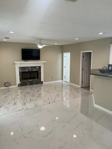 a living room with a flat screen tv and a fireplace