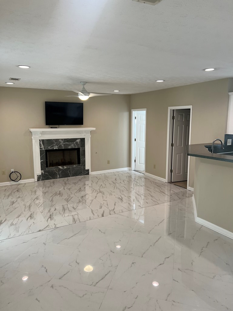 6528 Yellow Stone Court Columbus, GA 31909 - Photo 17 of 29 a living room with a flat screen tv and a fireplace