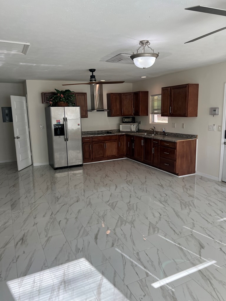 6528 Yellow Stone Court Columbus, GA 31909 - Photo 18 of 29 a large white kitchen with a stove a sink dishwasher and a microwave oven in a kitchen