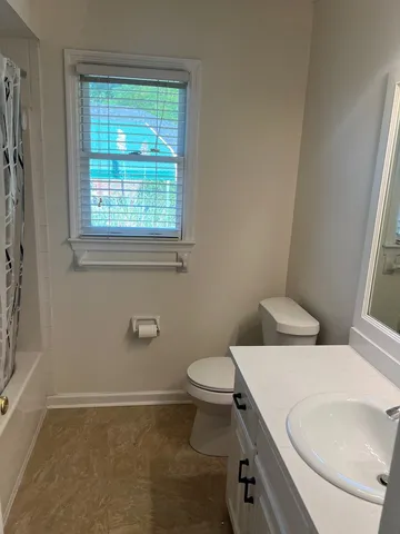 a white toilet sitting next to a bathroom sink