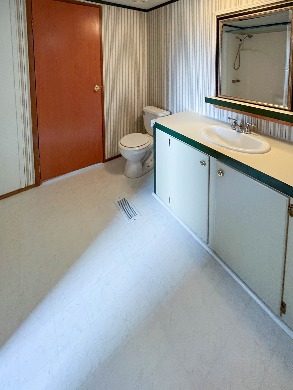 552 Rackley Road Goodspring, TN 38460 - Photo 21 of 26 a bathroom with a granite countertop sink a toilet and mirror