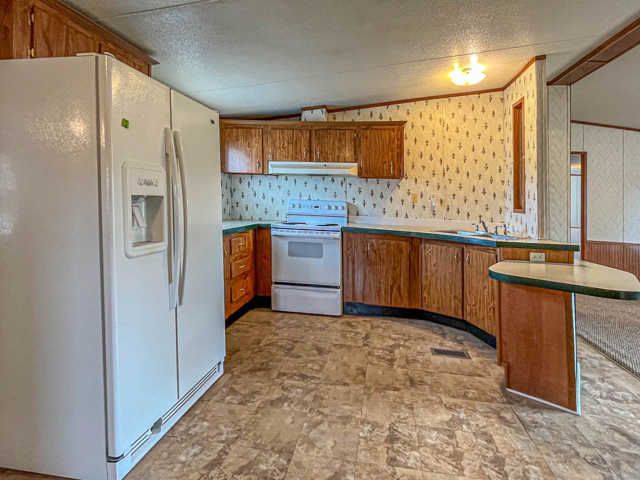 552 Rackley Road Goodspring, TN 38460 - Photo 7 of 26 a kitchen with stainless steel appliances granite countertop a refrigerator and a sink