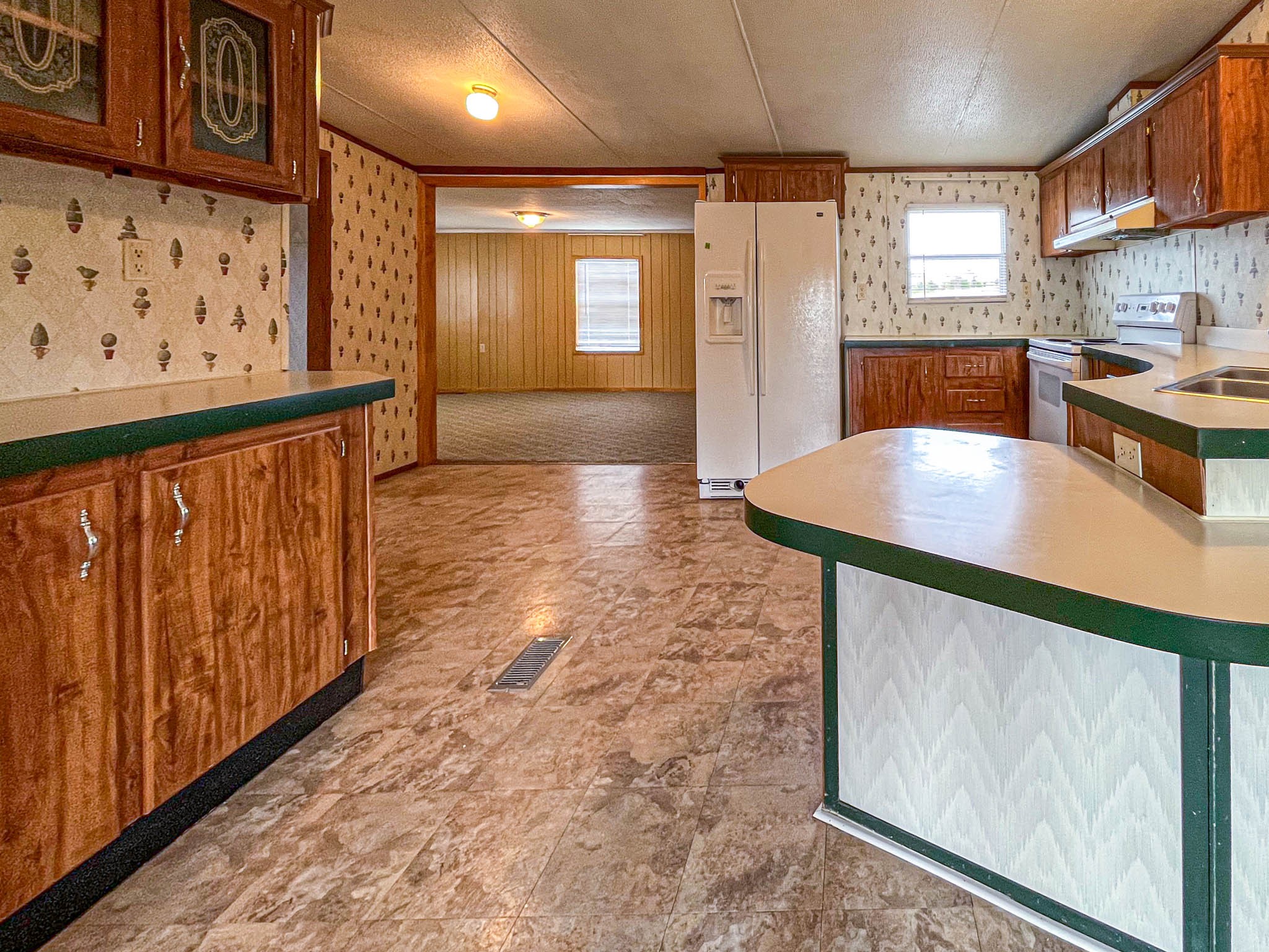 552 Rackley Road Goodspring, TN 38460 - Photo 8 of 26 a kitchen with stainless steel appliances granite countertop a refrigerator a stove and a wooden cabinets