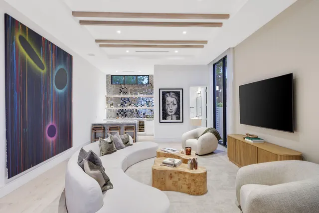 a living room with patio furniture and a floor to ceiling window