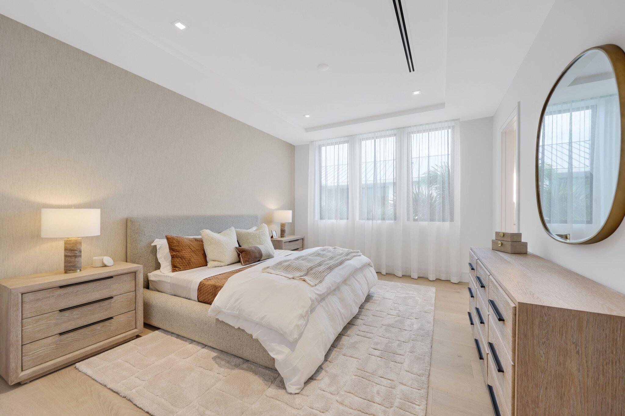 340 Grove Place Delray Beach, FL 33444 - Photo 64 of 95 a bedroom with a bed a mirror and a large window