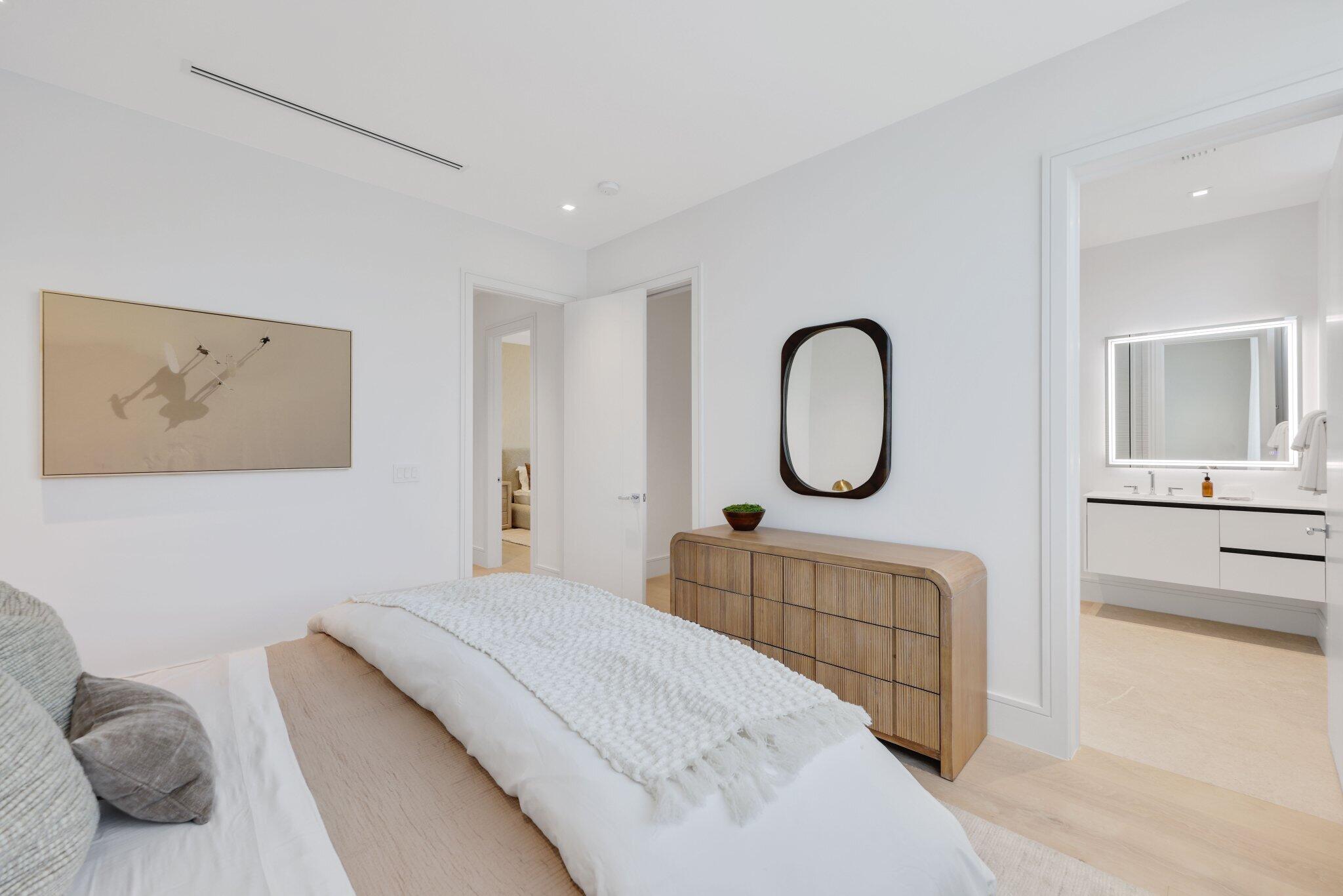 340 Grove Place Delray Beach, FL 33444 - Photo 68 of 95 a bedroom with a large bed and a chandelier