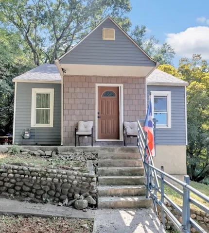 a front view of a house with stairs