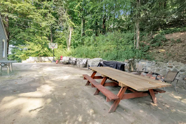 a view of a backyard with a table and chairs