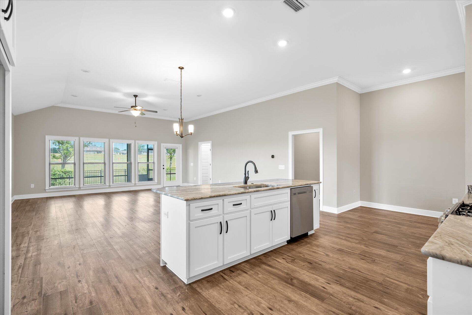 8934 Skip Stone Road Milton, FL 32583 - Photo 18 of 55 a large kitchen with granite countertop a large window a sink and stainless steel appliances
