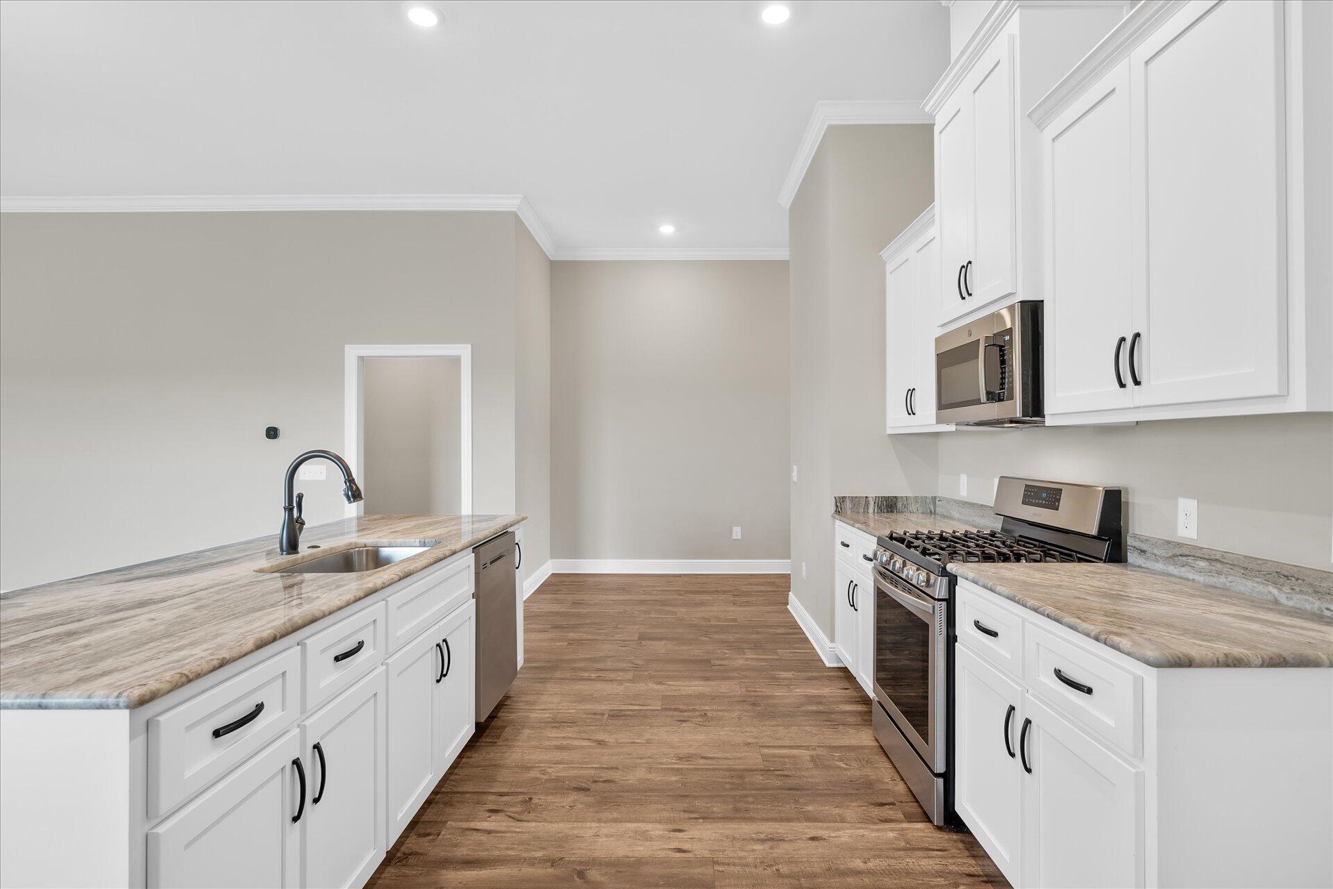 8934 Skip Stone Road Milton, FL 32583 - Photo 19 of 55 a kitchen with granite countertop a sink and cabinets