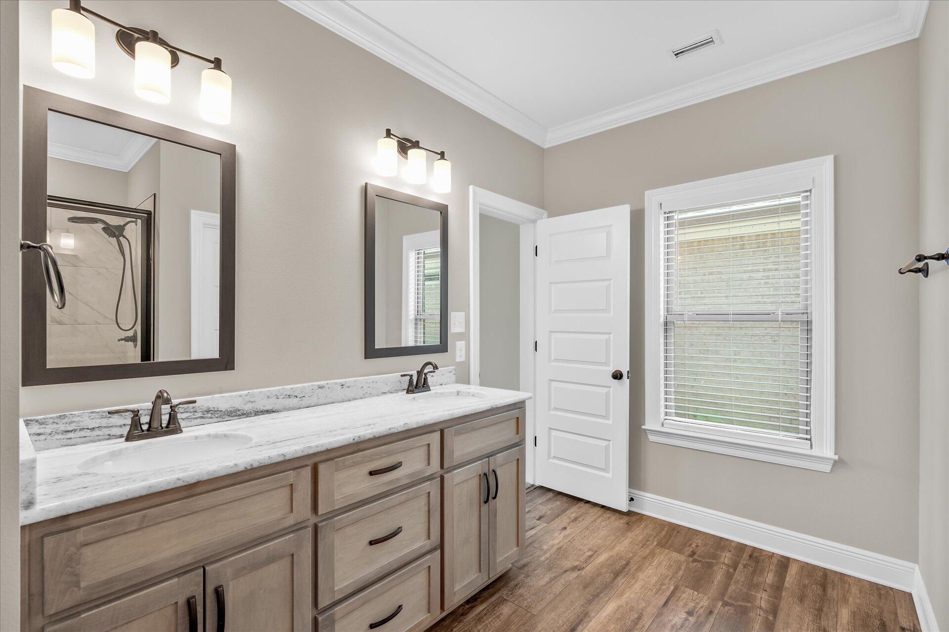 8934 Skip Stone Road Milton, FL 32583 - Photo 30 of 55 a bathroom with a double vanity sink and a mirror