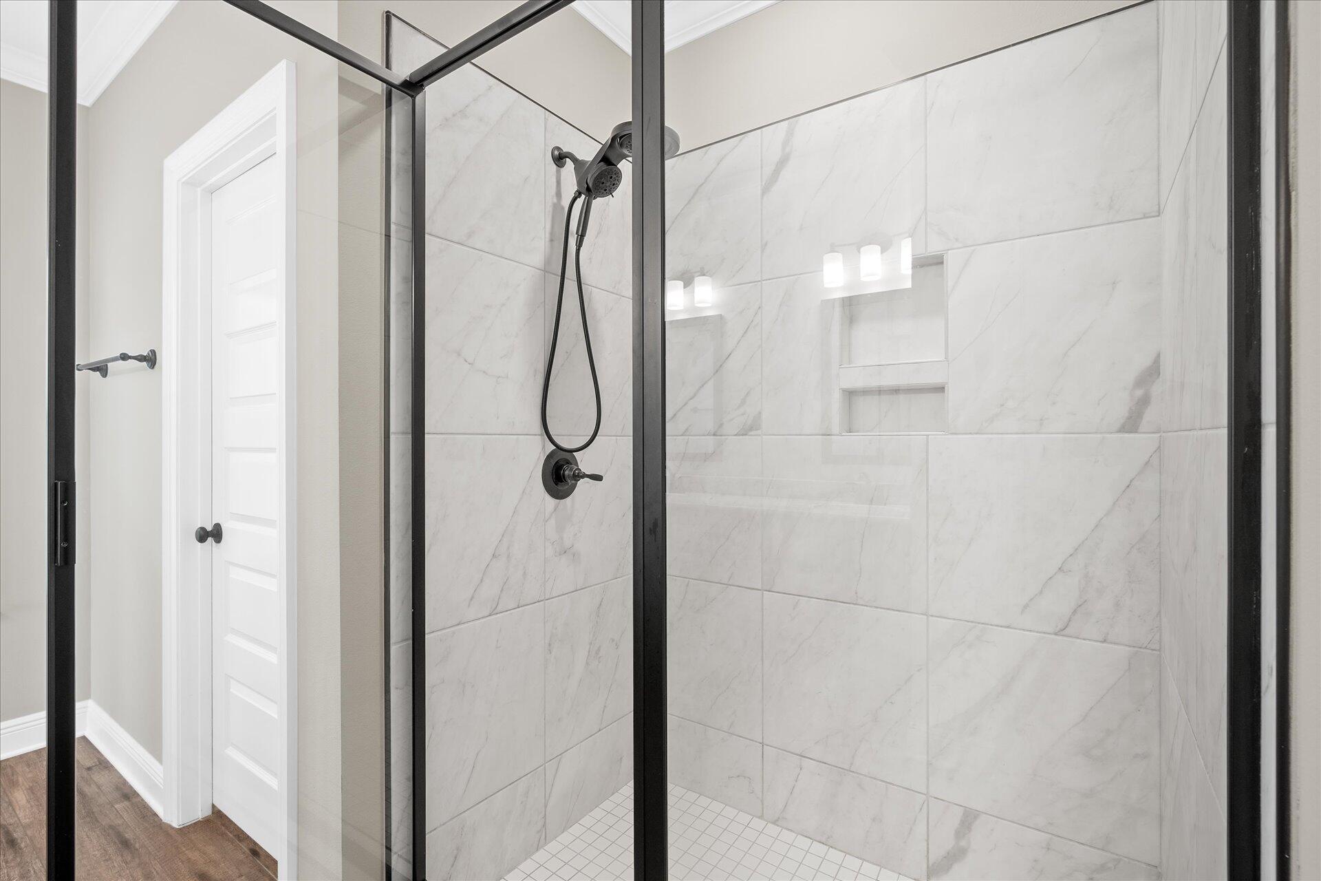 8934 Skip Stone Road Milton, FL 32583 - Photo 31 of 55 a bathroom with a glass shower door