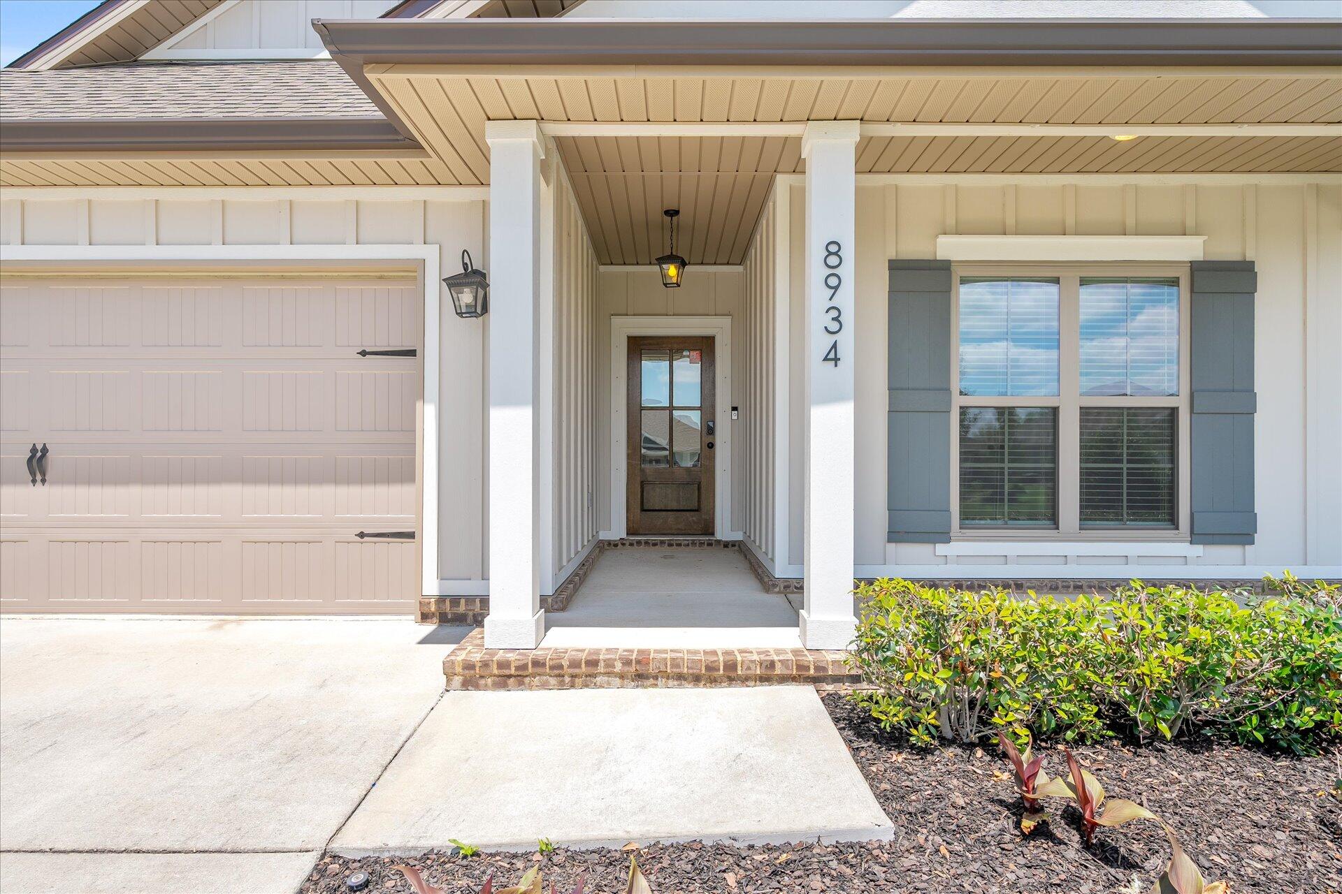 8934 Skip Stone Road Milton, FL 32583 - Photo 4 of 55 a front view of a house with a black gate