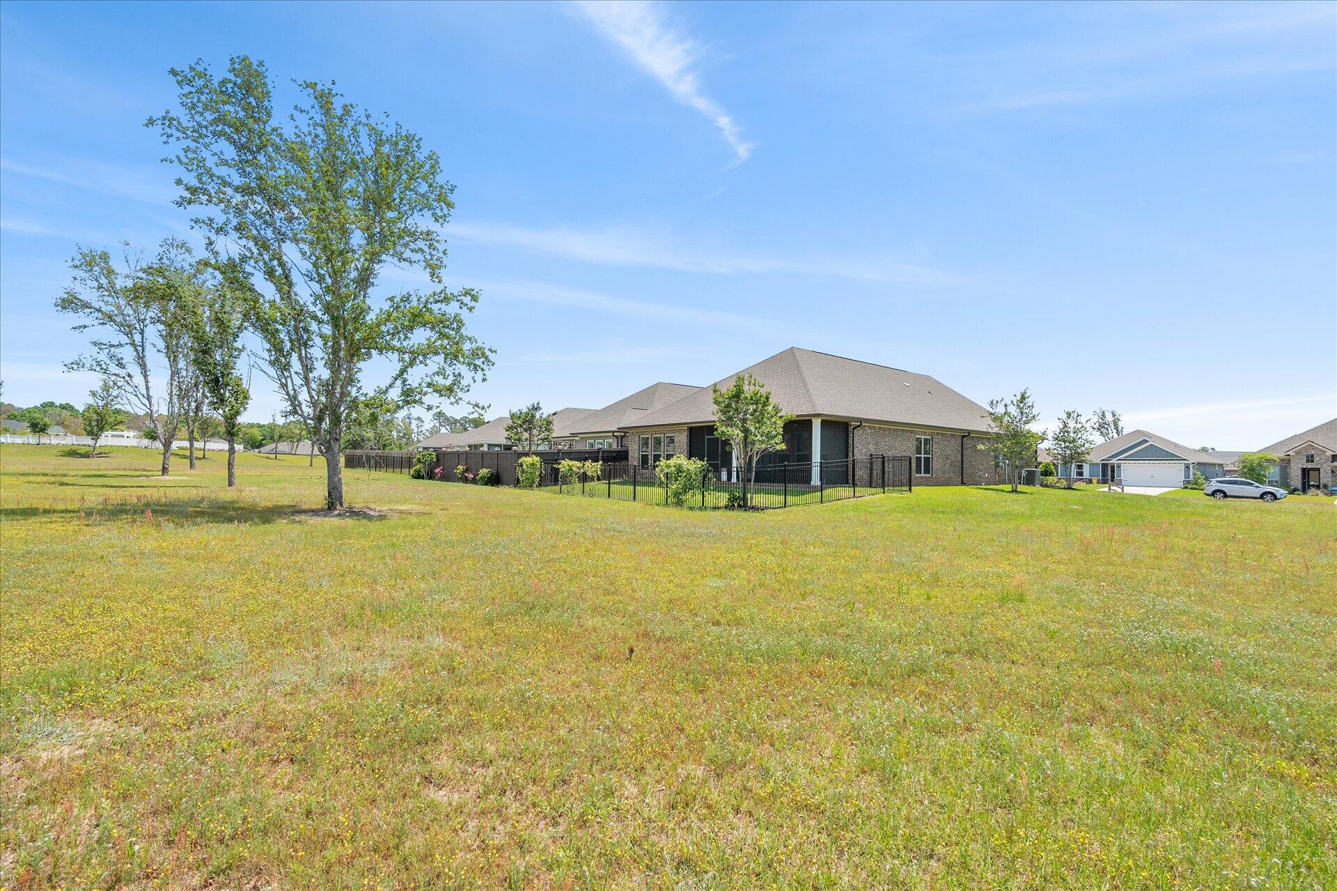 8934 Skip Stone Road Milton, FL 32583 - Photo 46 of 55 a front view of a house with a yard
