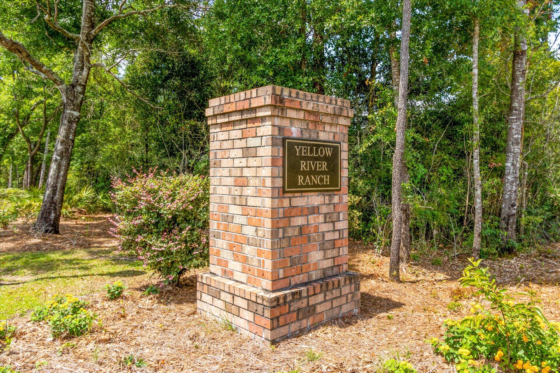 8934 Skip Stone Road Milton, FL 32583 - Photo 49 of 55 a brick building with a yard