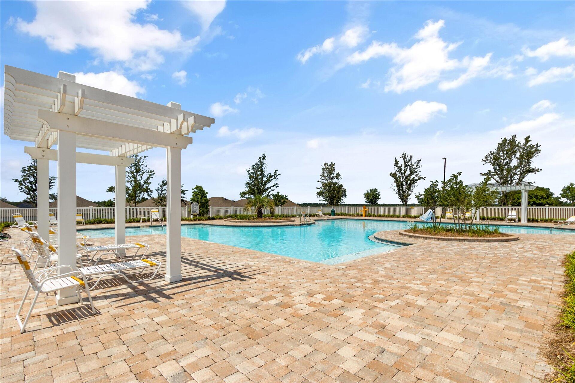 8934 Skip Stone Road Milton, FL 32583 - Photo 51 of 55 a view of a swimming pool and lounge chairs