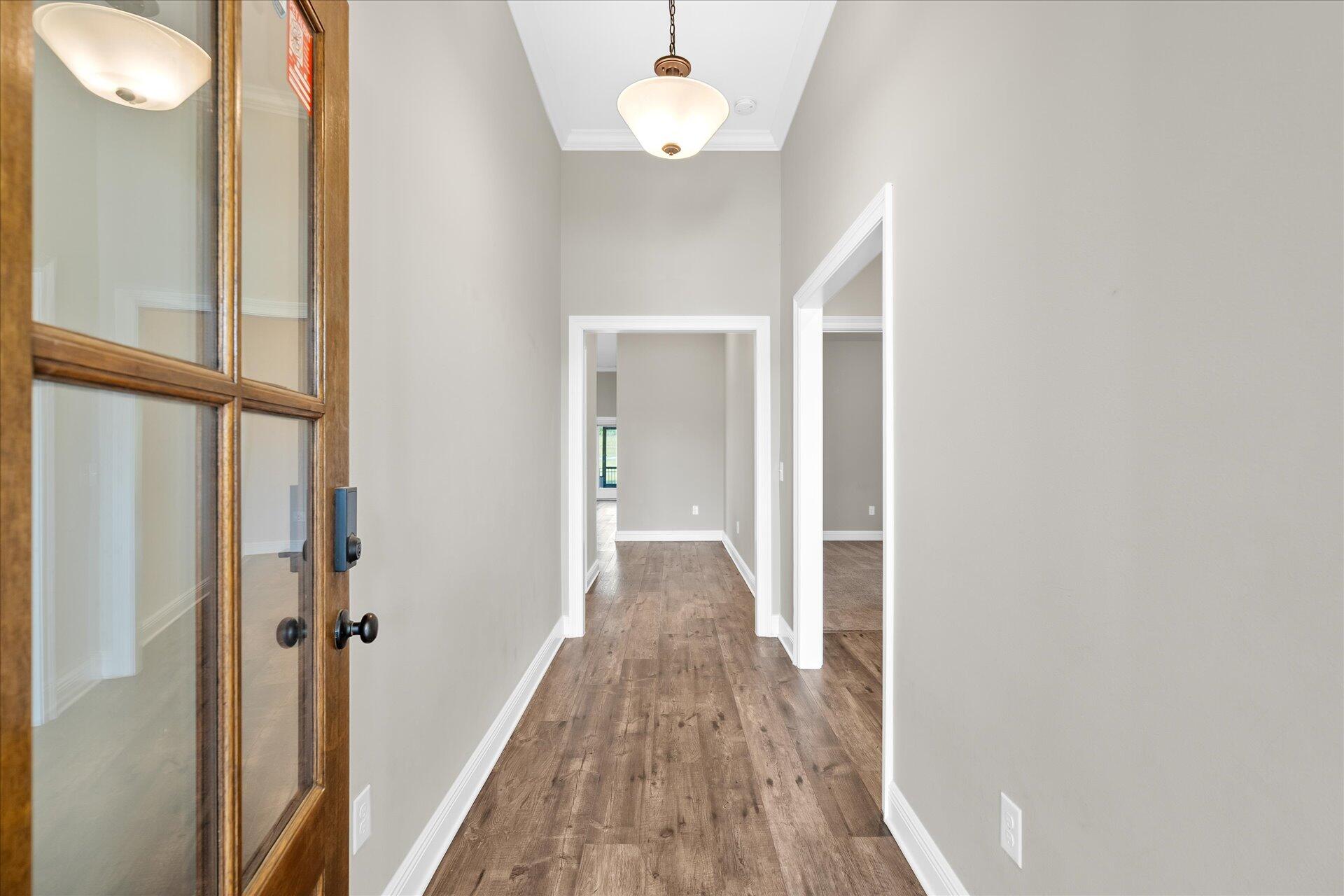 8934 Skip Stone Road Milton, FL 32583 - Photo 6 of 55 a view of a hallway with wooden floor and cabinet