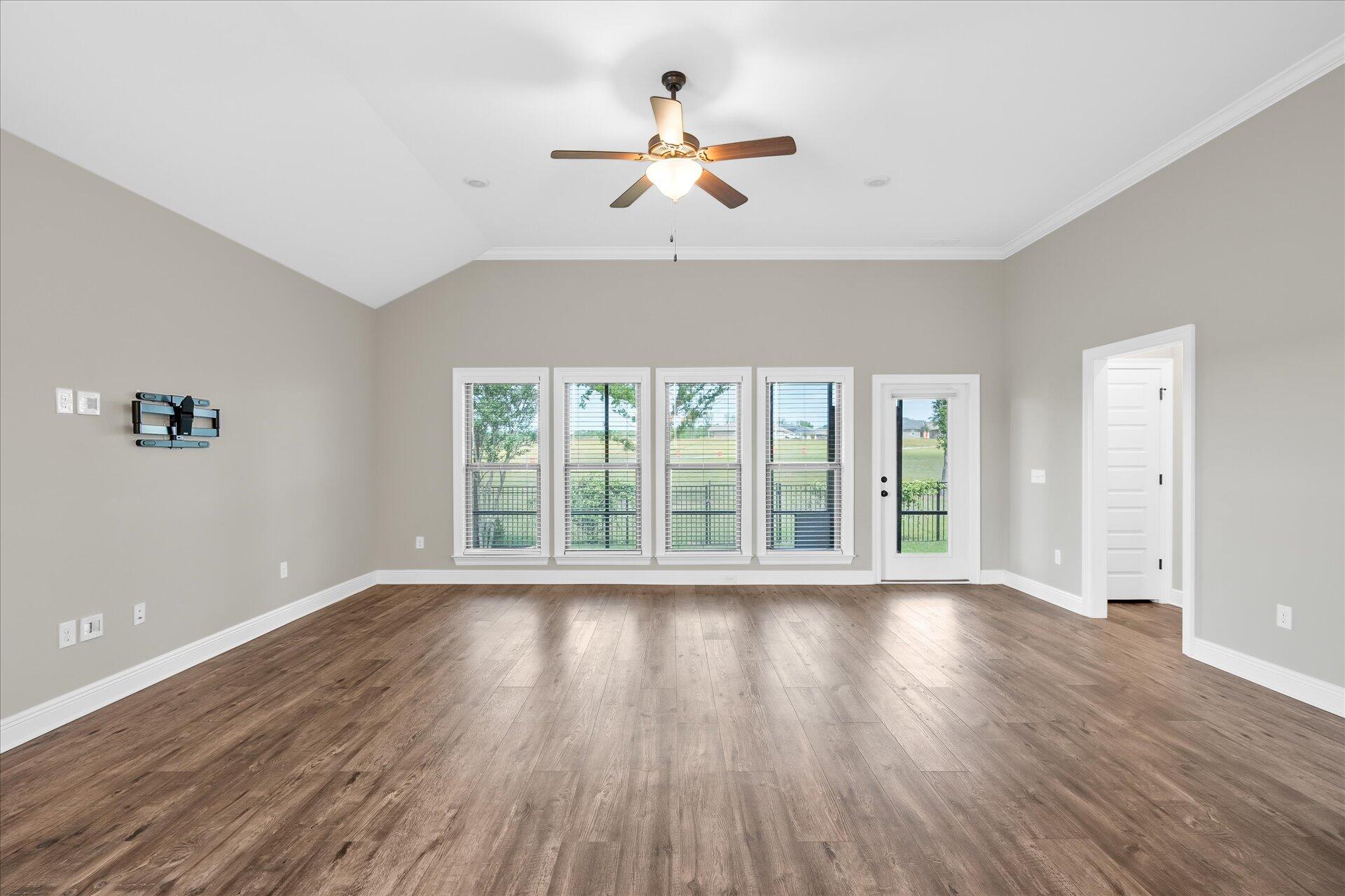 8934 Skip Stone Road Milton, FL 32583 - Photo 10 of 55 a view of an empty room with wooden floor and a window