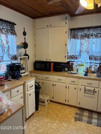 a dining room with furniture a chandelier and window
