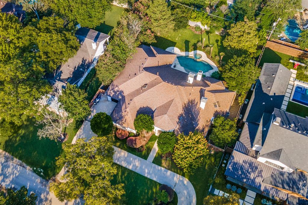 an aerial view of a house with a yard and plants