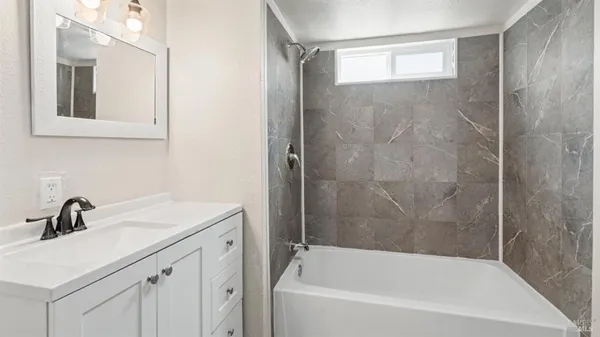 a bathroom with a sink a mirror and a bathtub