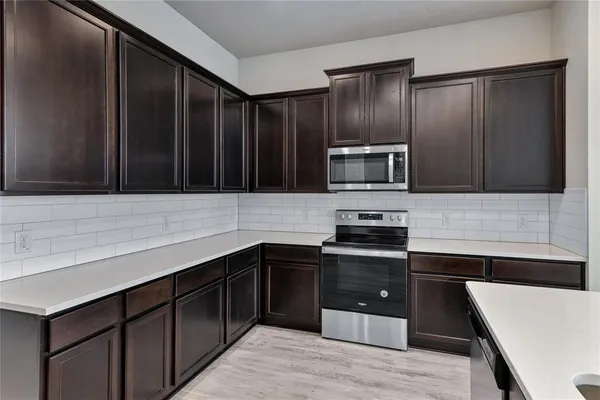a kitchen with sink cabinets and stainless steel appliances