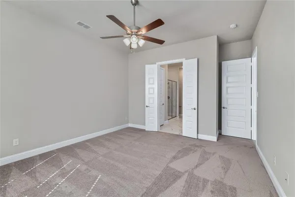 a view of a livingroom with a ceiling fan and window