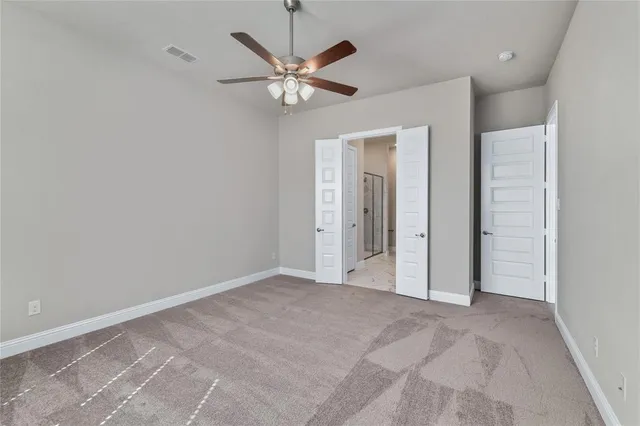 a view of a livingroom with a ceiling fan and window