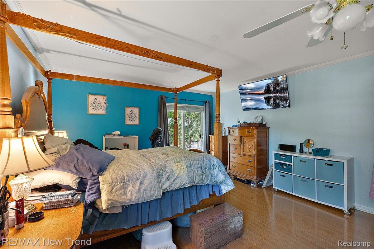 1450 Lenox Road Bloomfield Hills, MI 48304 - Photo 55 of 79 Wood-finish flooring with light-colored walls and a ceiling fan with integrated lighting