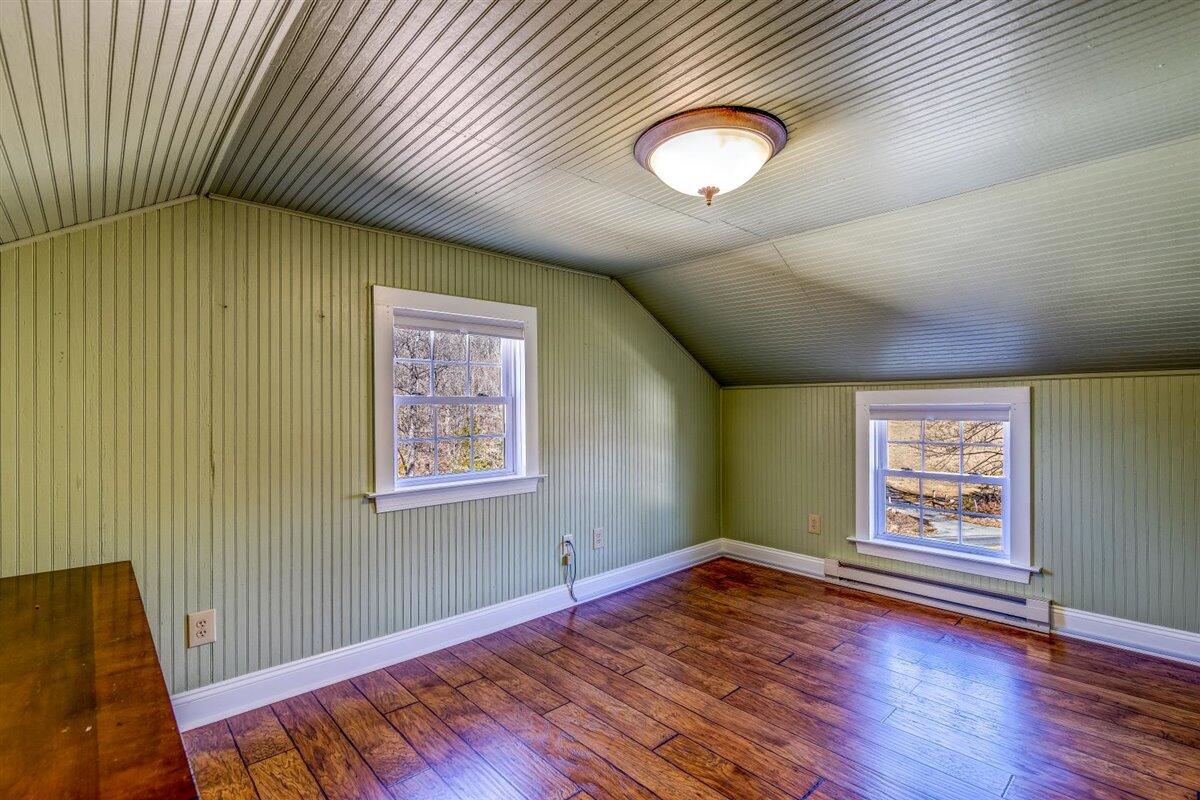 2717 Thompson Ridge Road Ferrum, VA 24088 - Photo 13 of 25 an empty room with wooden floor and windows