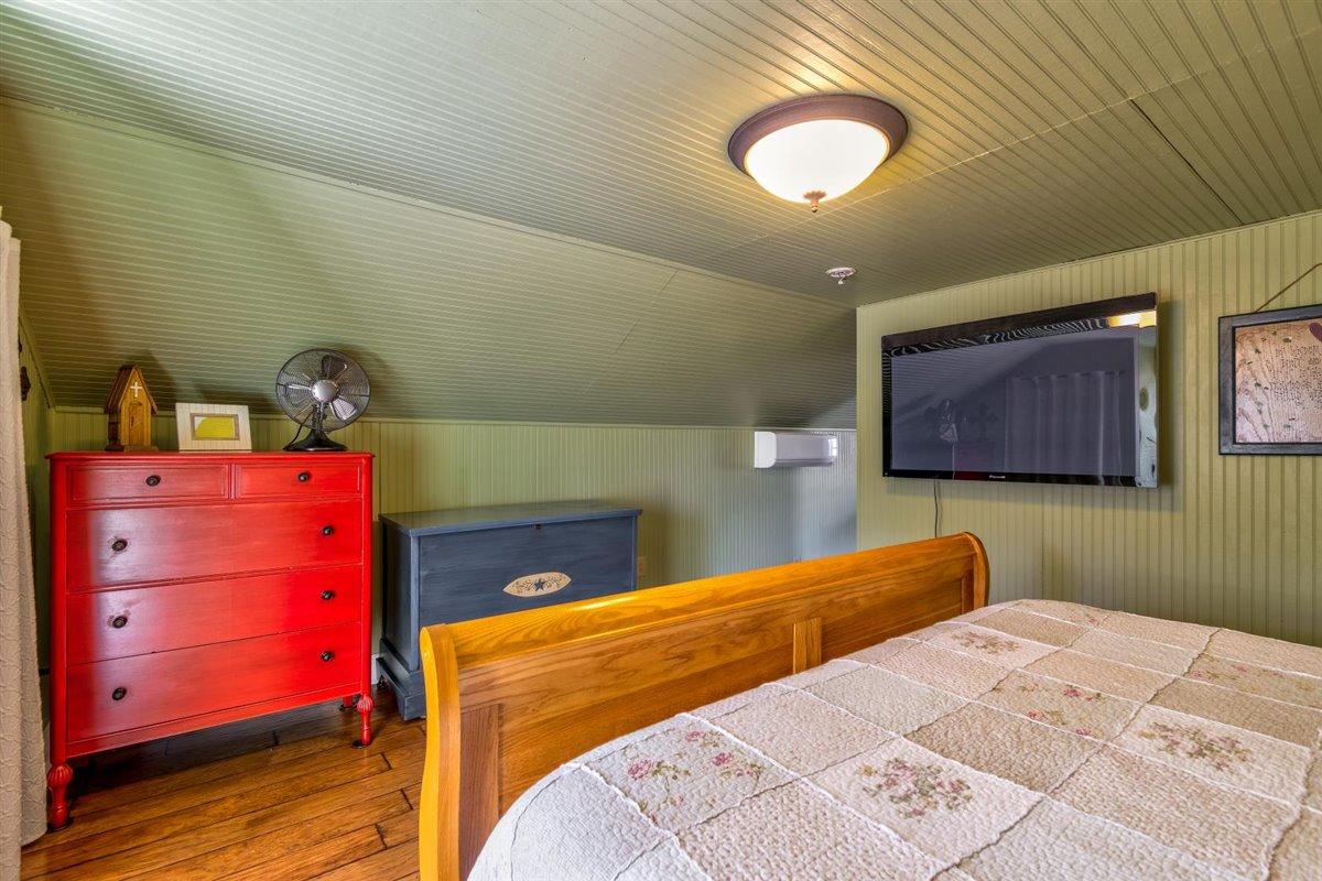 2717 Thompson Ridge Road Ferrum, VA 24088 - Photo 15 of 25 a bedroom with a bed and a lamp on dresser